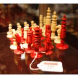 A set of 19th century turned ivory chess pieces, one side natural, and other side red stained,