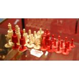 A set of 19th century turned bone chess pieces, one side natural, the other side red, height to king