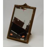 A 1950s easel dressing table mirror, the rectangular bevelled plate within a moulded gilt