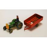 A Mettoy tinplate tractor, with driver and trailer