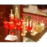 An incomplete set of 19th century carved bone chess pieces, one side natural, the other side red