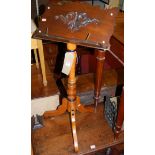 A late 19th century Continental turned and stained beech music stand, having telescopic action