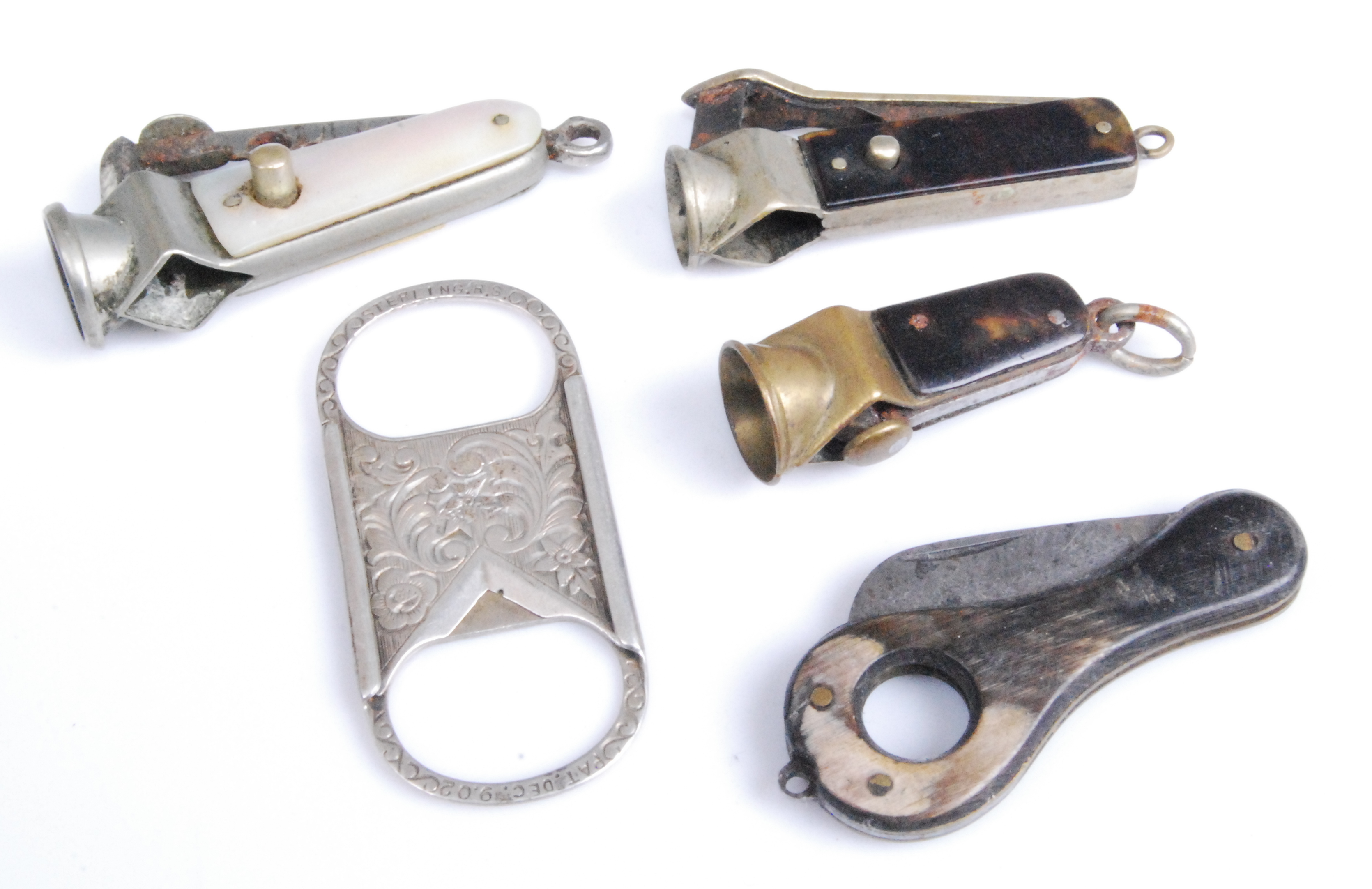 An early 20th century sterling silver pocket guillotine cigar cutter, having all-over foliate