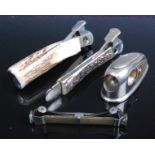 A steel cigar cutter having stag antler grips with cutter to one end and cigar box opener to the