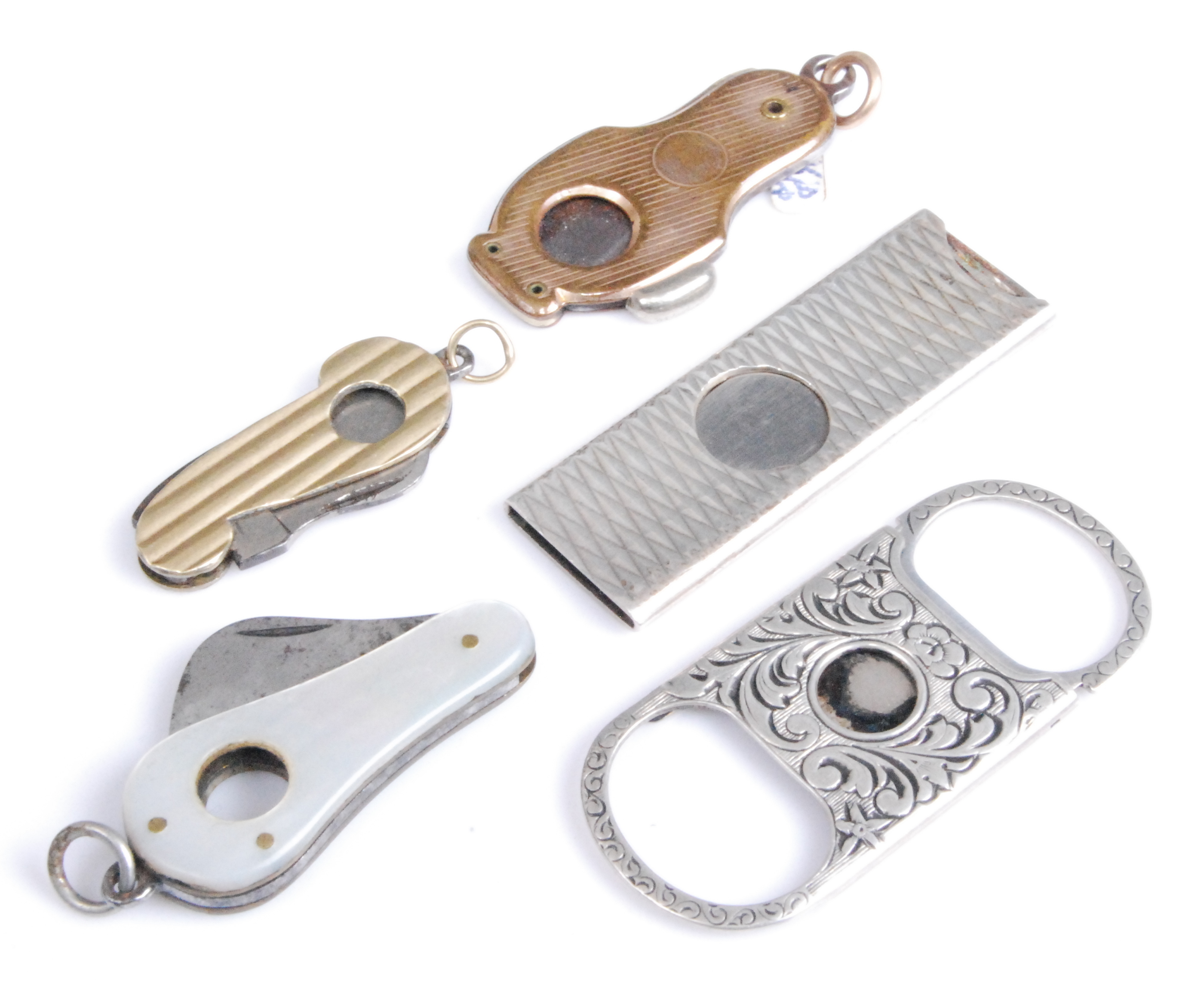 An early 20th century sterling silver pocket guillotine cigar cutter, having foliate engraved
