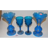 A pair of late 19th century continental blue glass vases, each having a flared rim to a slender neck