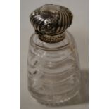 A circa 1900 glass scent bottle, of square tapered form, having star cut base, silver mounted cap