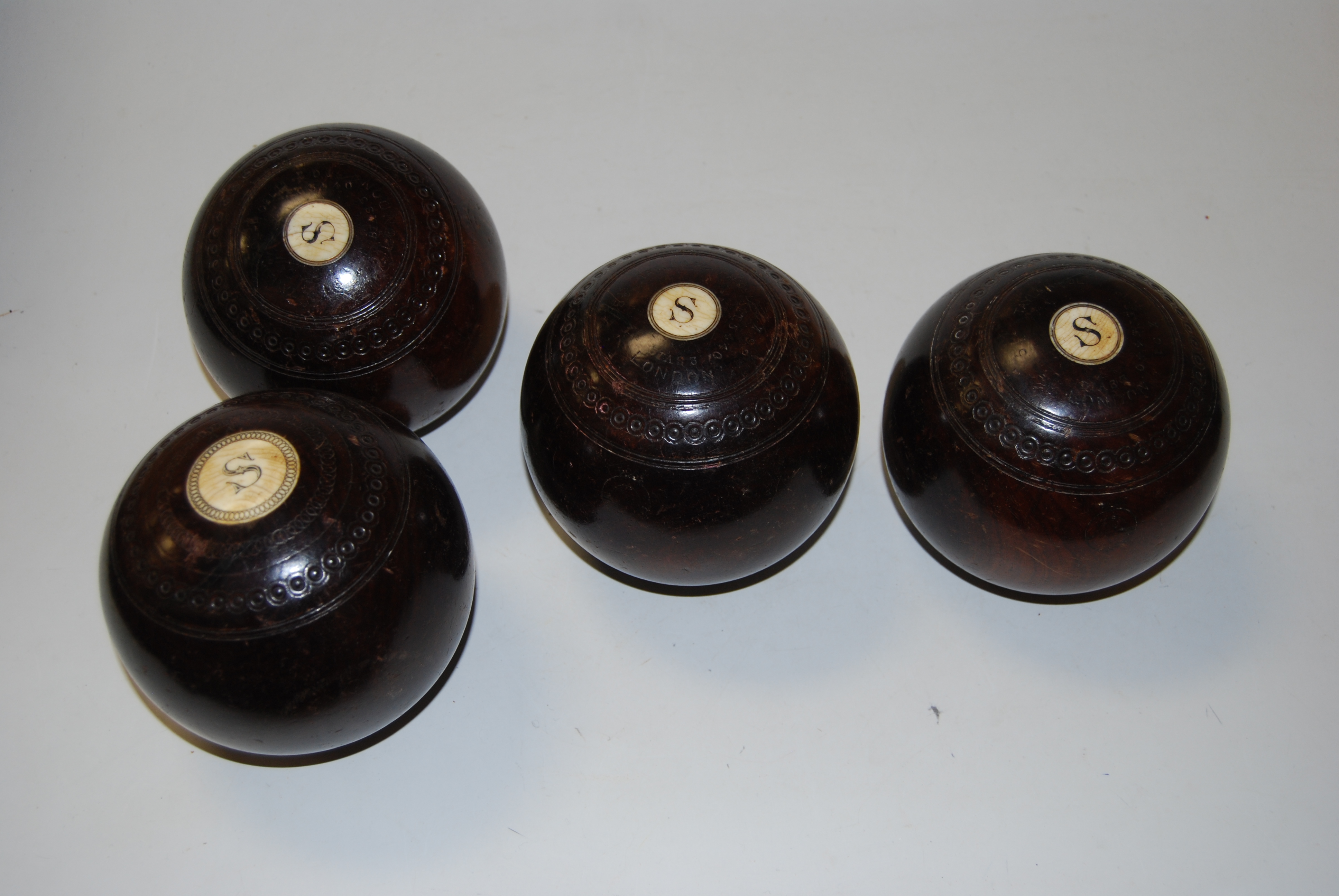 Four lignam vitae lawn bowls