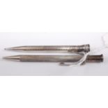 An engine turned silver propelling pencil; together with a silver plated example (2)