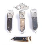 An early 20th century textured white metal pocket cigar cutter having a folding steel blade together