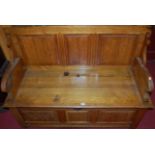 A circa 1900 oak three panelled fold-over settle, having typical hinged box seat base with fluted