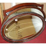 An oak framed bevelled oval wall mirror, and two others (3)