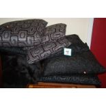 A collection of various black floral stylised large scatter cushions