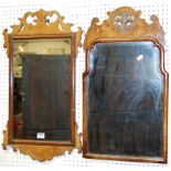 Two early Georgian style walnut and figured walnut fret carved wall mirrors