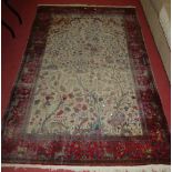 A Persian silk woven cream ground 'Tree of Life' rug, the ground with trailing and further exotic