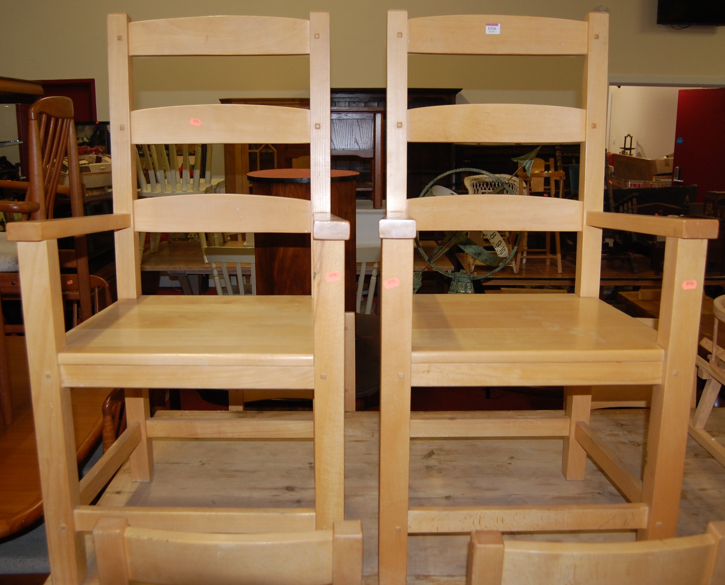 A pair of contemporary beech panelled seat ladderback elbow chairs; together with a set of six