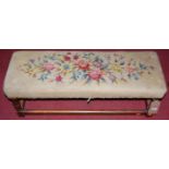 An early 20th century oak framed and floral needlework upholstered long footstool, width 92cm