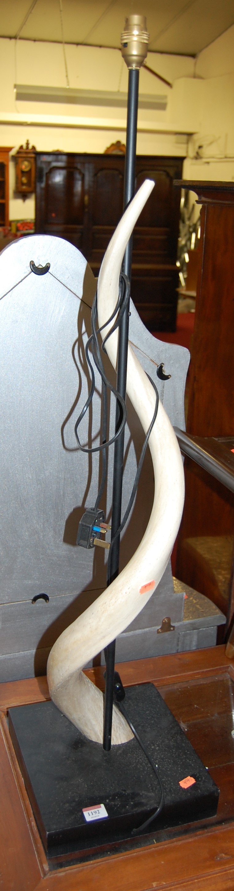 A contemporary low floorlight mounted with a faux Kudu horn, height 106cm