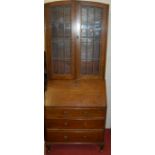 A 1930s oak and lead glazed bureau bookcase, width 75cm