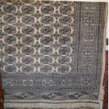 A large Persian woollen Bokhara rug, having typical trailing tramline borders, 290 x 185cm