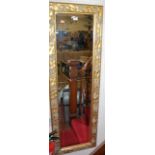 A contemporary floral gilt framed rectangular bevelled wall mirror, 135x44cm