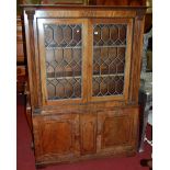 A 19th century mahogany and later adapted bookcase cupboard, having twin lead glazed upper doors