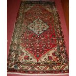 A Persian woollen red ground Tabriz rug, 221 x 106cm