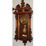 An early 20th century walnut Vienna droptrunk wall clock