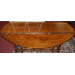 A 17th century style joined oak dropleaf wake table, having opposing twin gateleg action, on