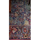 A large Persian blue ground Tabriz carpet, having a heavy floral ground and further decorated with