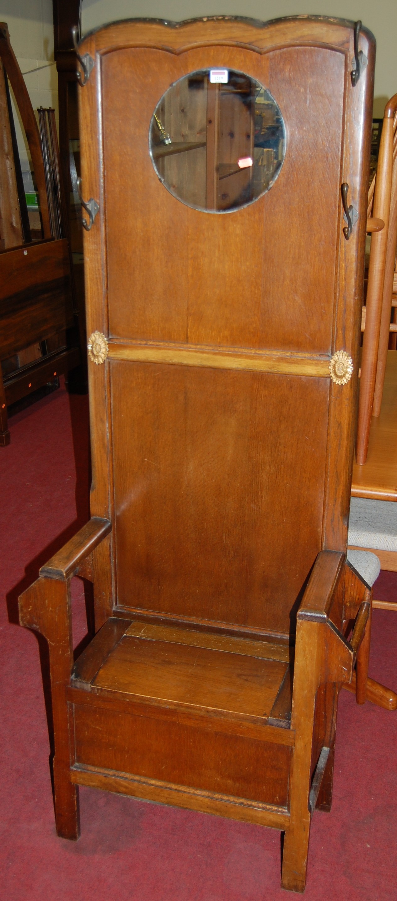 A 1930s panelled oak mirrorback hall seat, having hinged boxseat base, w.71cm