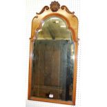 An early Georgian style walnut and figured walnut shell capped arched bevelled wall mirror, 89x46cm