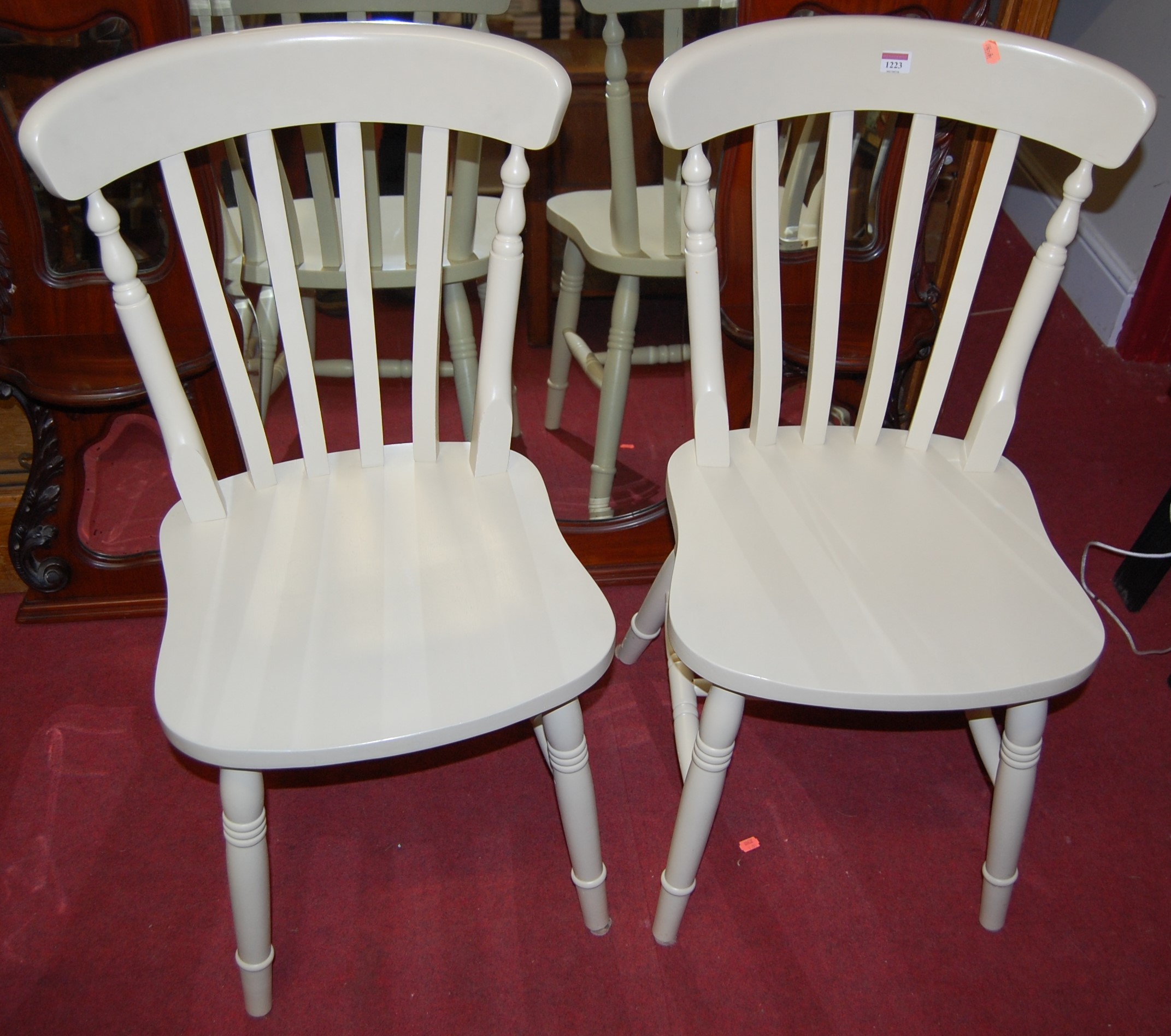 A set of six contemporary cream painted beech slatback kitchen chairs