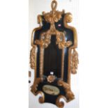 A reproduction Continental style black painted and gilt decorated heavy framed bevelled wall mirror,