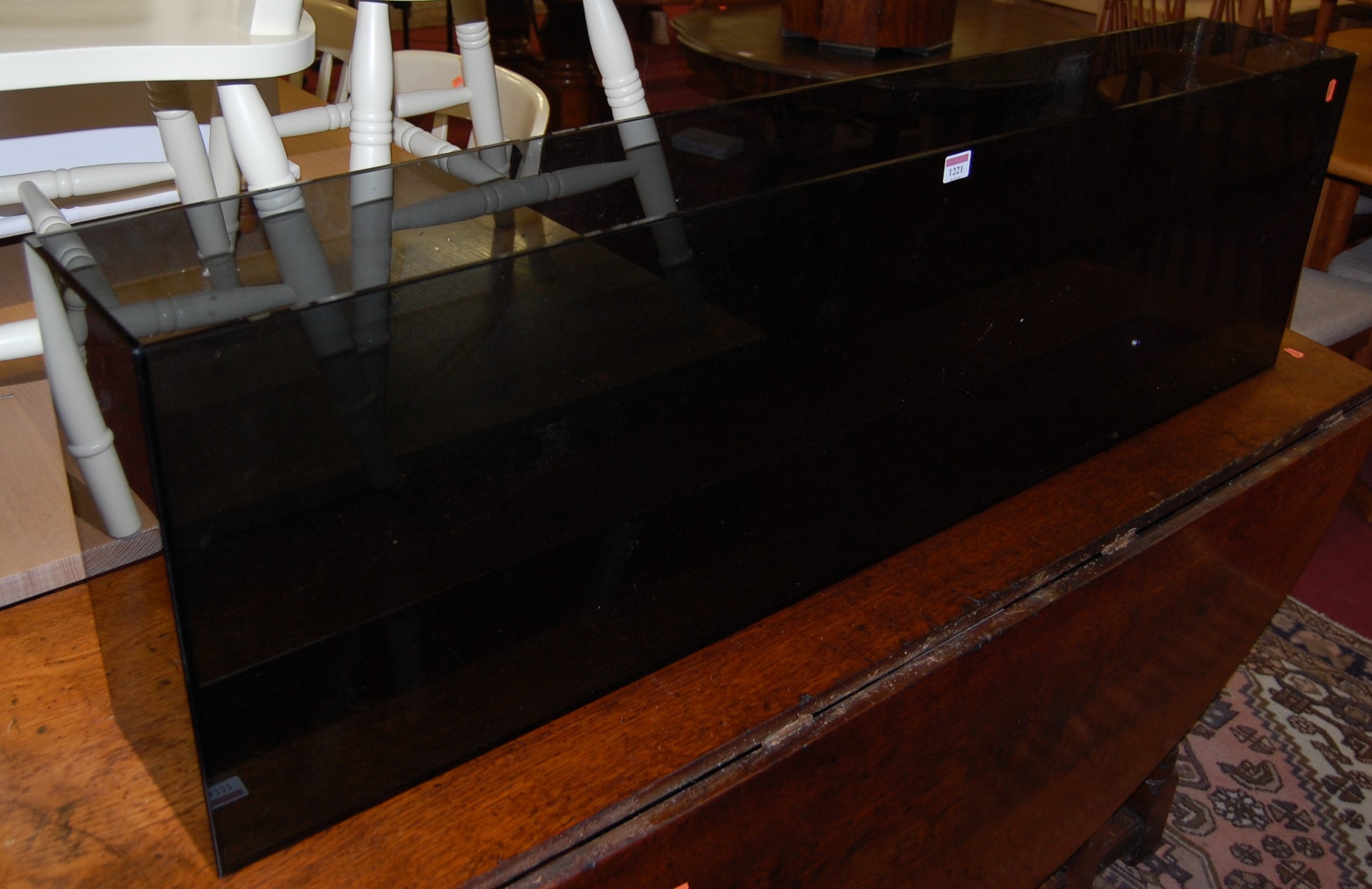 A smoked heavy glass long display stand, w.136cm