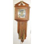 A contemporary German stained pine hanging open wall clock, having a silvered and brass dial with