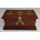 A late Victorian oak table-top casket, of rectangular form, the cover having brass strapwork hinges,