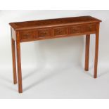 A figured walnut and crossbanded five-drawer hall table, in the 18th century style, raised on