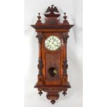 A circa 1900 carved walnut Vienna wall clock, the case surmounted with an eagle pediment over two