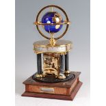 A Franklin Mint Royal Geographical Society Millennium Clock, the gilded blue glass globe orbited