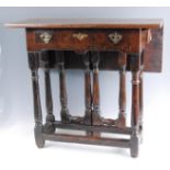 An antique oak and walnut dropflap side table, having associated walnut single dropflap top on