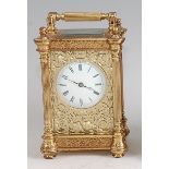 An early 20th century French gilt brass carriage clock, having a convex white metal dial within an