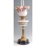 A late Victorian brass pedestal oil lamp, having opaque glass shade polychrome painted with