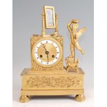A mid-19th century French gilt bronze mantel clock, the dial flanked by a winged cherub and