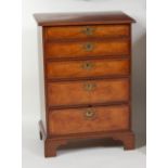 A figured walnut and crossbanded five-drawer chest, 18th century and recently re-veneered, the top