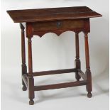 An antique joined oak side table, having a three plank top over single frieze drawer, w.68cm, d.