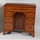 A figured walnut and crossbanded kneehole desk, 18th century and recently re-veneered, the top