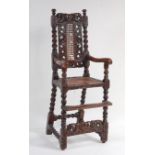 A late 17th century carved walnut childs high-chair, the back centred with a crown flanked by