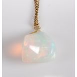 A yellow metal abstract opal pendant, attached to a filed curblink chain, opal dimensions approx