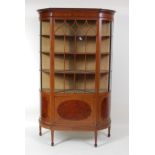 An Edwardian mahogany and inlaid breakfront china display cabinet, the glazed door with satinwood